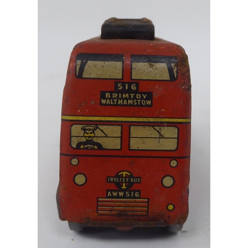 197 - Two vintage tinplate model toys, viz. a Brimtoy double decker trolley bus; and a Tri-ang Minic Toys ... 