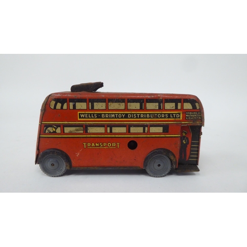 197 - Two vintage tinplate model toys, viz. a Brimtoy double decker trolley bus; and a Tri-ang Minic Toys ... 