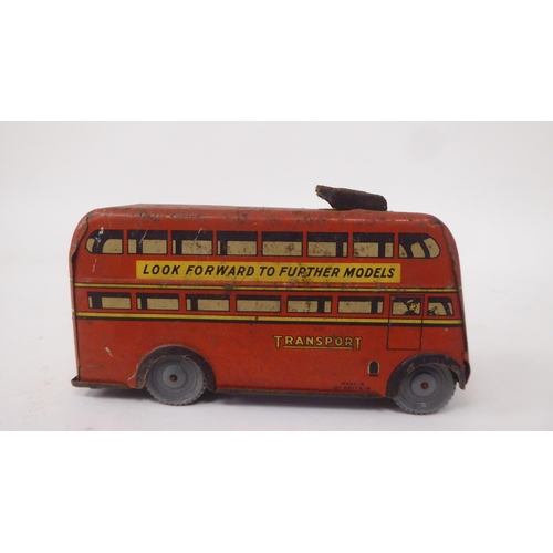 197 - Two vintage tinplate model toys, viz. a Brimtoy double decker trolley bus; and a Tri-ang Minic Toys ... 