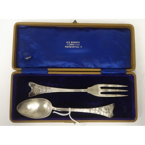 206 - An Arts & Crafts spot-hammered silver presentation dessert spoon and fork  bearing initials on t... 