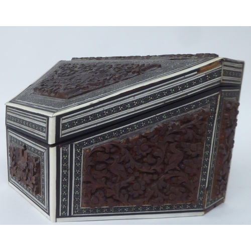 219 - An early 20thC Anglo-Indian carved and inlaid hardwood and bone desktop stationery box of trapezium ... 