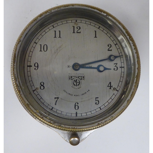 222 - A vintage Smiths of Cricklewood Works motorcar dashboard timepiece with a bezel winder and silvered ... 