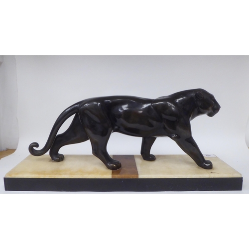 228 - After Rochard - an Art Deco patinated spelter model, a prowling panther, on a multi-coloured alabast... 