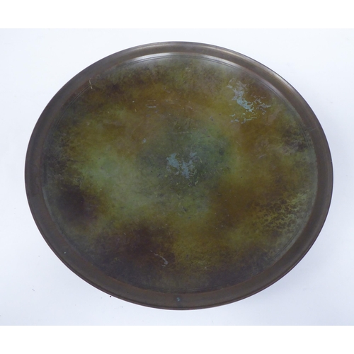 233 - A Just Anderson part-patinated green and brown bronze, footed, shallow dish with a double tramline e... 