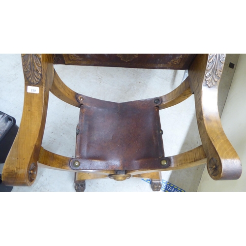 239 - A late 19th/early 20thC Southern European walnut framed Savonarola design chair with rosette and aca... 