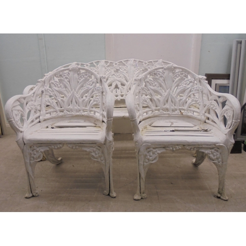 244 - A vintage Victorian inspired, white painted, cast metal suite of terrace furniture, in the style of ... 