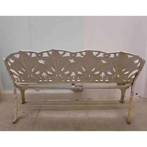 244 - A vintage Victorian inspired, white painted, cast metal suite of terrace furniture, in the style of ... 