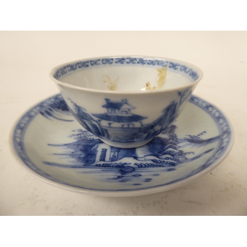 248 - A Nanking Cargo porcelain tea bowl and saucer, traditionally decorated in blue and white  bearing or... 