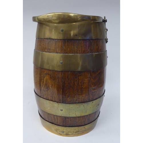 250 - A late 19thC coopered oak and brass bound bucket with a swing handle  bears the engraved legend... 