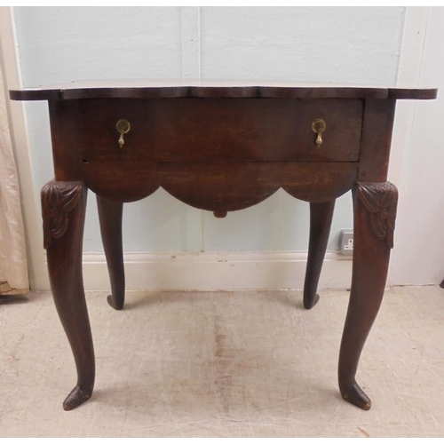 255 - An early 18thC possibly Irish oak lowboy, the planked top with a shaped border and apron, incorporat... 