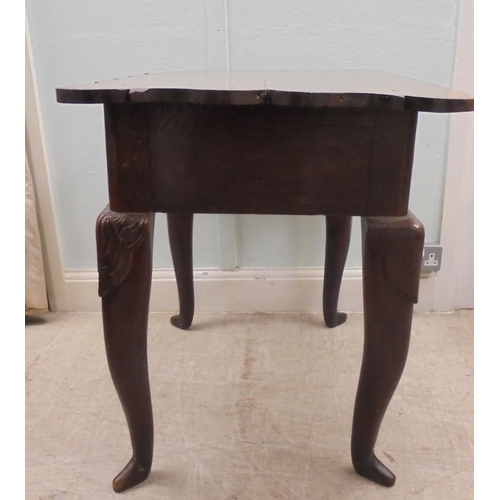 255 - An early 18thC possibly Irish oak lowboy, the planked top with a shaped border and apron, incorporat... 