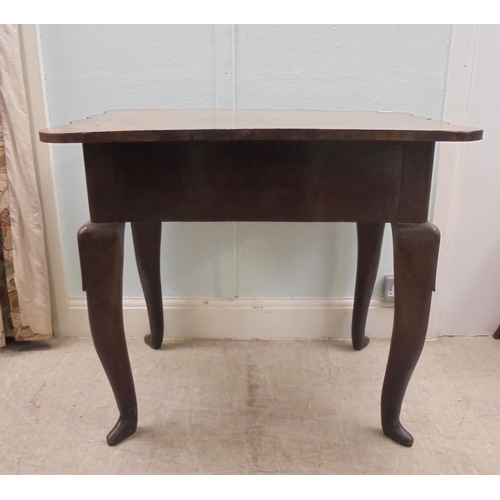 255 - An early 18thC possibly Irish oak lowboy, the planked top with a shaped border and apron, incorporat... 