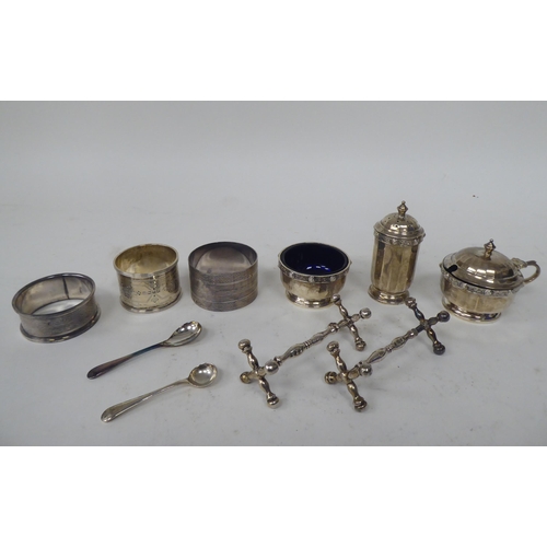 257 - Silver collectables: to include a three piece condiments set with Celtic band ornament; and a pair o... 