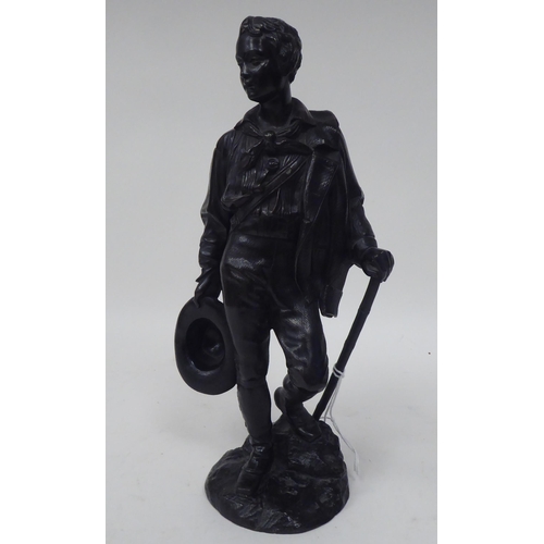 259 - A Calmels - a black painted bronze figure, an itinerant young man with a coat and hat  bears a ... 