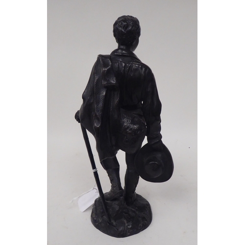 259 - A Calmels - a black painted bronze figure, an itinerant young man with a coat and hat  bears a ... 