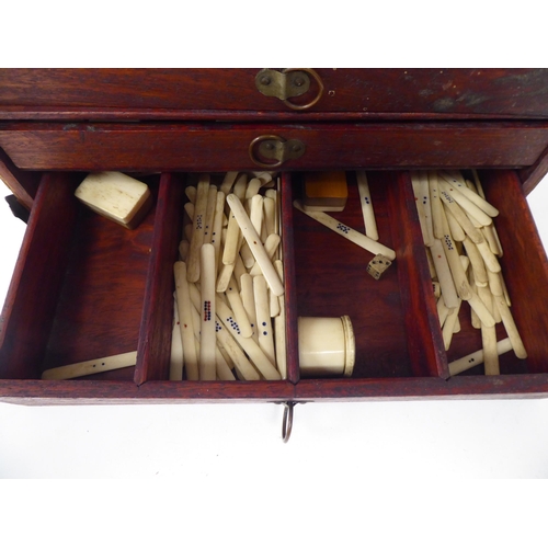 261 - A Mah Jong set with engraved bone sticks and tiles  (completeness not guaranteed) contained in ... 