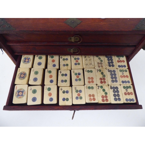 261 - A Mah Jong set with engraved bone sticks and tiles  (completeness not guaranteed) contained in ... 