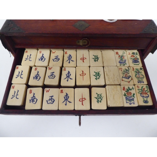 261 - A Mah Jong set with engraved bone sticks and tiles  (completeness not guaranteed) contained in ... 