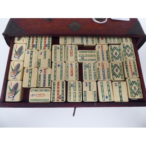 261 - A Mah Jong set with engraved bone sticks and tiles  (completeness not guaranteed) contained in ... 