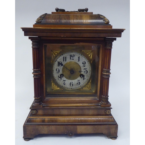 274 - An early 20thC walnut veneered cased bracket clock with brass mounts and a folding top handle; the m... 