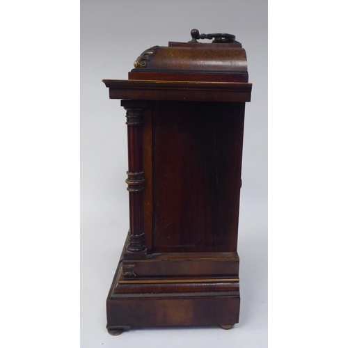 274 - An early 20thC walnut veneered cased bracket clock with brass mounts and a folding top handle; the m... 