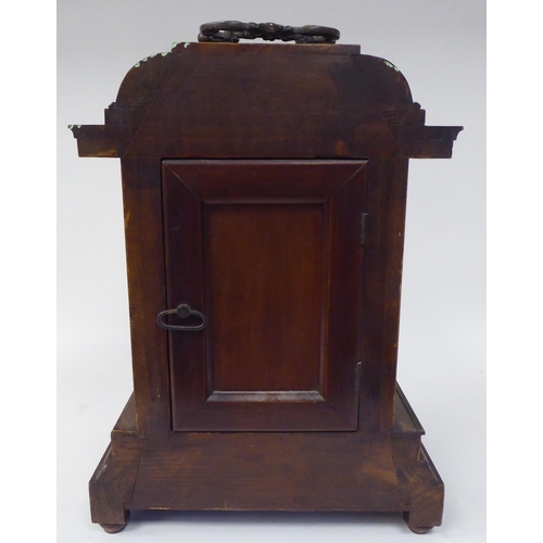 274 - An early 20thC walnut veneered cased bracket clock with brass mounts and a folding top handle; the m... 