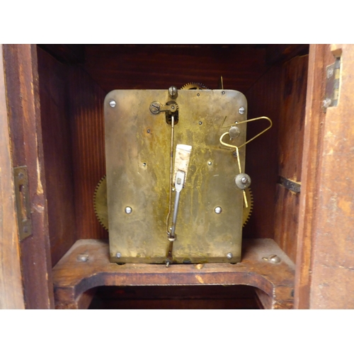 274 - An early 20thC walnut veneered cased bracket clock with brass mounts and a folding top handle; the m... 