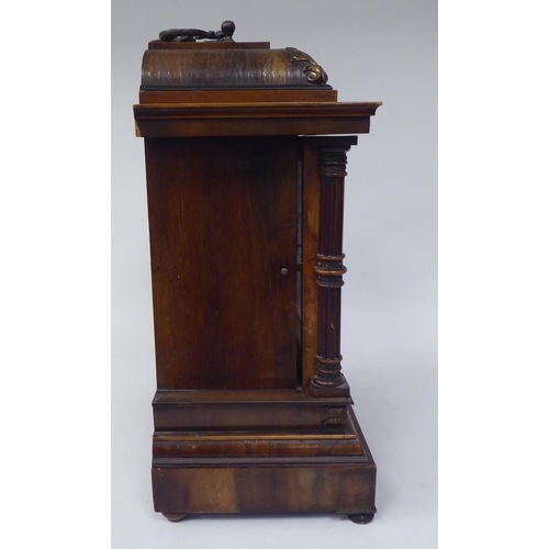 274 - An early 20thC walnut veneered cased bracket clock with brass mounts and a folding top handle; the m... 