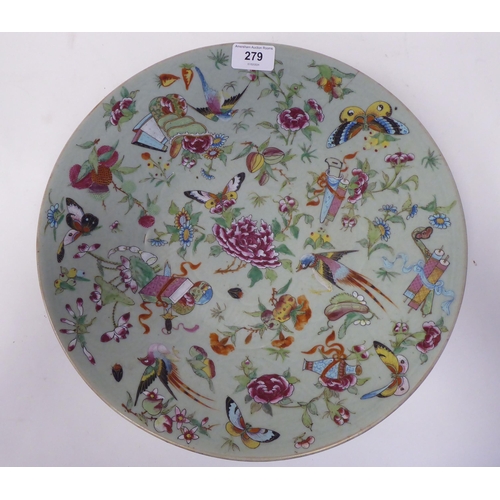 279 - A 19thC Chinese celadon glazed, footed porcelain dish, decorated with small artefacts, songbirds, so... 