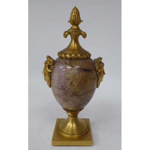 283 - A 19thC ormolu mounted, ovoid shape Blue John cassolette with opposing female masks, adorned by frui... 