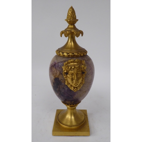 283 - A 19thC ormolu mounted, ovoid shape Blue John cassolette with opposing female masks, adorned by frui... 