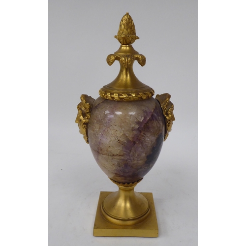 283 - A 19thC ormolu mounted, ovoid shape Blue John cassolette with opposing female masks, adorned by frui... 