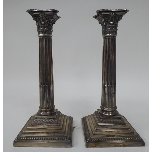 35 - A pair of loaded silver Corinthian column candlesticks with detachable, bead bordered sconces and st... 