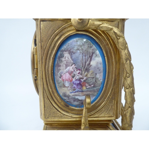 43 - A late 19thC Continental gilt metal cased mantel clock, set with painted porcelain panels; the 8 day... 