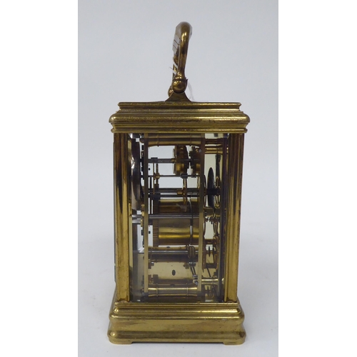 47 - A late 19thC lacquered brass cased carriage timepiece with bevelled glass panels; the movement faced... 