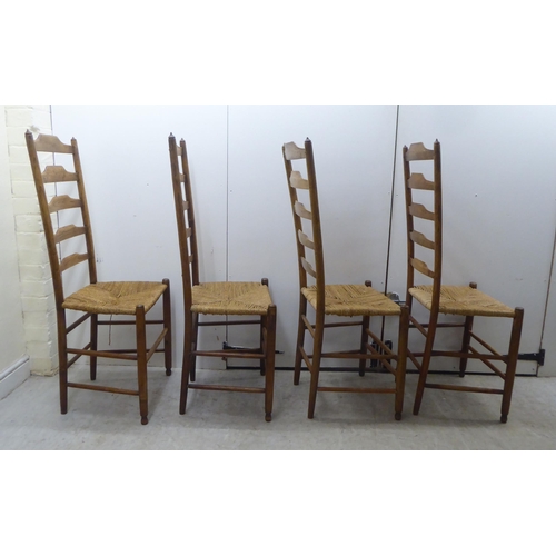 51 - A set of seven 19thC country made oak framed ladderback dining chairs with woven string seats, raise... 