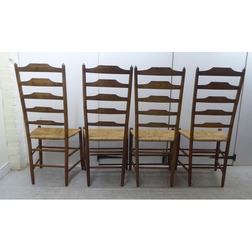 51 - A set of seven 19thC country made oak framed ladderback dining chairs with woven string seats, raise... 