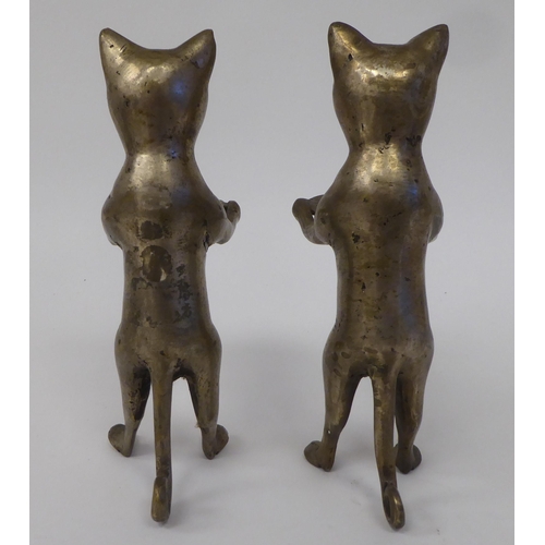 55 - A pair of nickel plated metal novelty model cats, each fashioned on a dumb waiter bearing a tray  6.... 