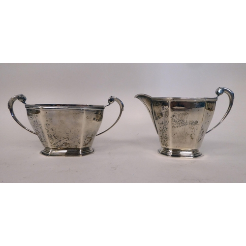 56 - An Art Deco three piece silver tea set of panelled, octagonal form, the teapot with a swept spout, i... 