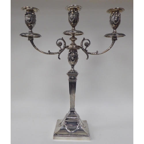 64 - An Edwardian loaded silver two part table candelabrum of Neo Classical design, comprising three vase... 