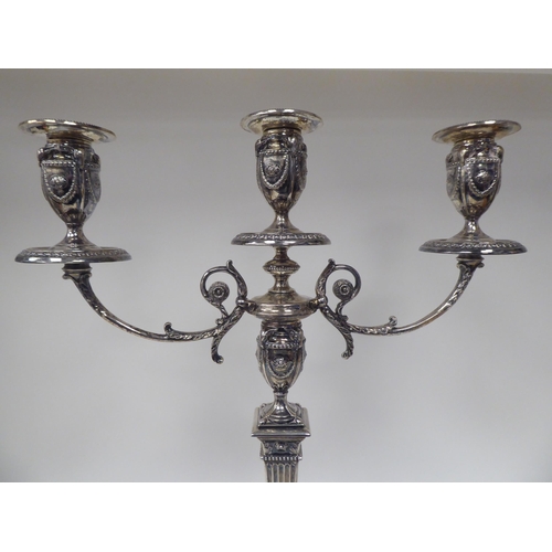 64 - An Edwardian loaded silver two part table candelabrum of Neo Classical design, comprising three vase... 