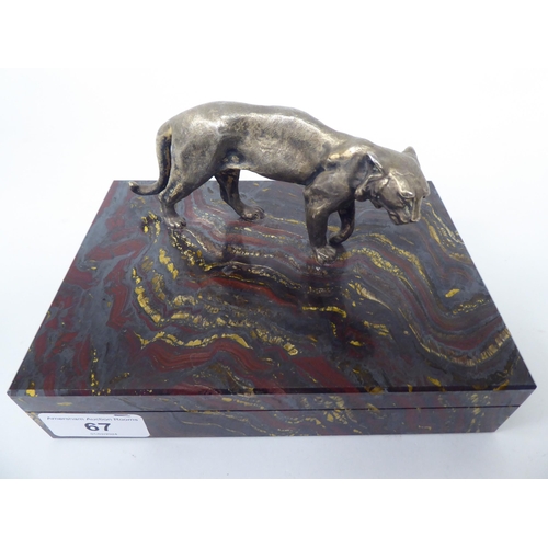 67 - A Tiger Ironstone cigarette box of shallow form with a standing, textured gilded metal big cat, poss... 