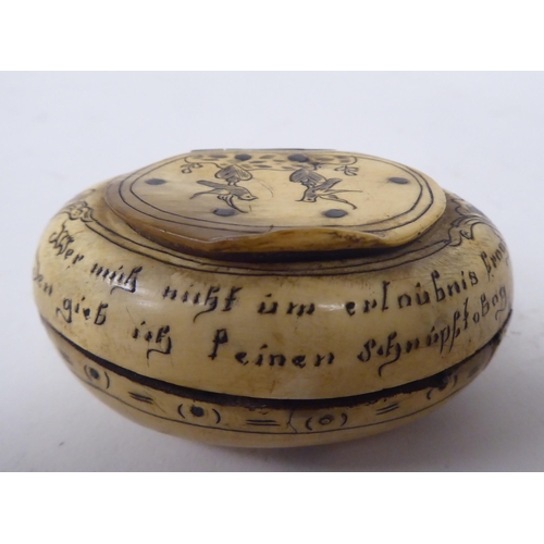 68 - An 18thC, possibly Dutch, scratch engraved bone, oval, cushion shape snuff box with a hinged lid, fe... 