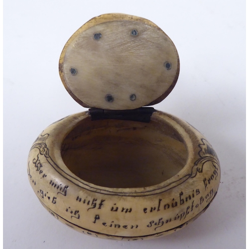 68 - An 18thC, possibly Dutch, scratch engraved bone, oval, cushion shape snuff box with a hinged lid, fe... 