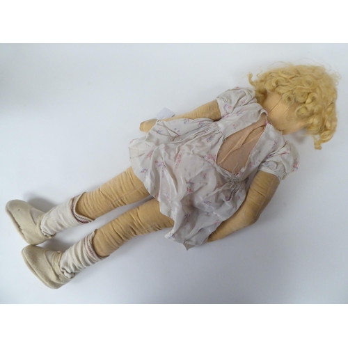 77 - An early 20thC doll, the moulded and painted head on a fabric body  27