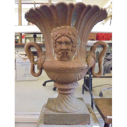 89 - A cast iron terrace urn with a flared rim, opposing ring handles and masks, on a pedestal foot  30