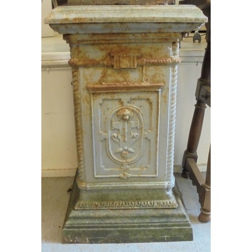 89 - A cast iron terrace urn with a flared rim, opposing ring handles and masks, on a pedestal foot  30