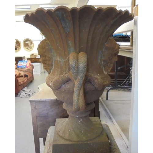 89 - A cast iron terrace urn with a flared rim, opposing ring handles and masks, on a pedestal foot  30