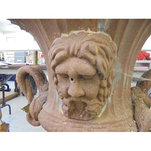 89 - A cast iron terrace urn with a flared rim, opposing ring handles and masks, on a pedestal foot  30