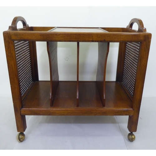 105 - A modern walnut finished magazine rack with twin cut-out handles and woven split cane panels, separa... 